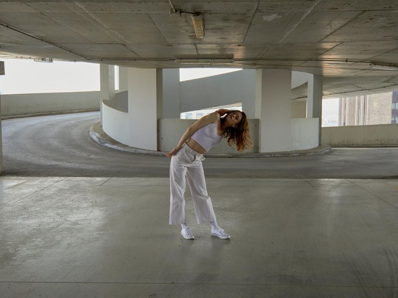 Person performing a dynamic yoga flow in a minimalist setting.